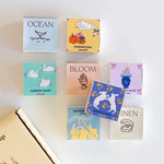 Sekiz koku barı kutusu yan yana: Ocean, Garden Magic, Bloom, Linen ve diğerleri