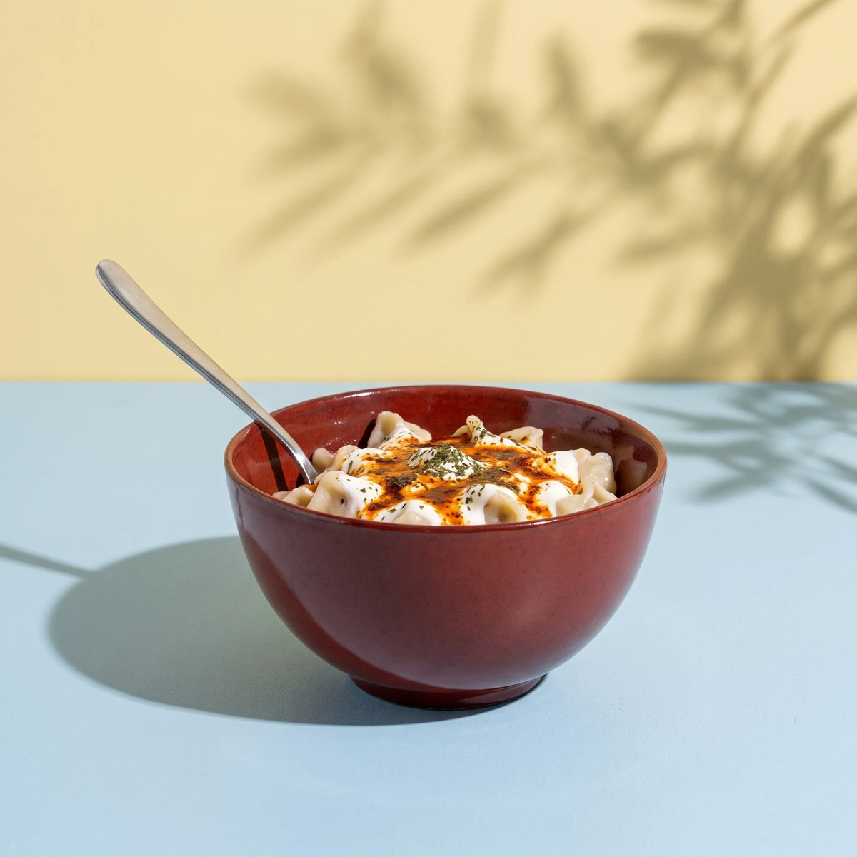Dem Kırmızı stoneware çorba kasesinde yoğurtlu mantı